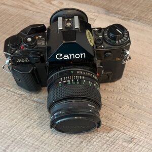 Canon A-1 35mm SLR Film Camera with Attached Black Lens